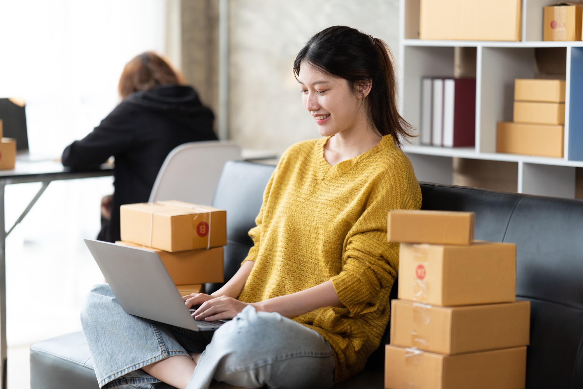Asian woman business owner works with a box at home, prepare parcel delivery SME supply chain.